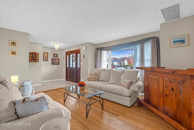 a view of a dining room with furniture and chandelier
