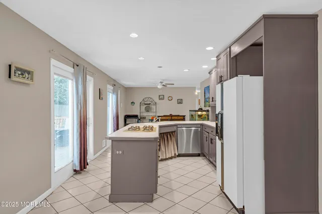 a view of a livingroom with workspace and a window