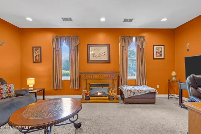 a bedroom with a bed and a flat tv screen on dresser