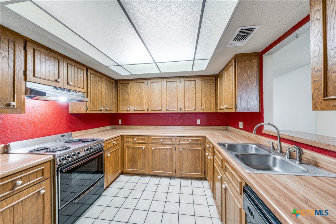 111 Oldtowne Road Seguin, TX 78155 - Photo 13 of 31 a kitchen with a sink stove top oven and cabinets