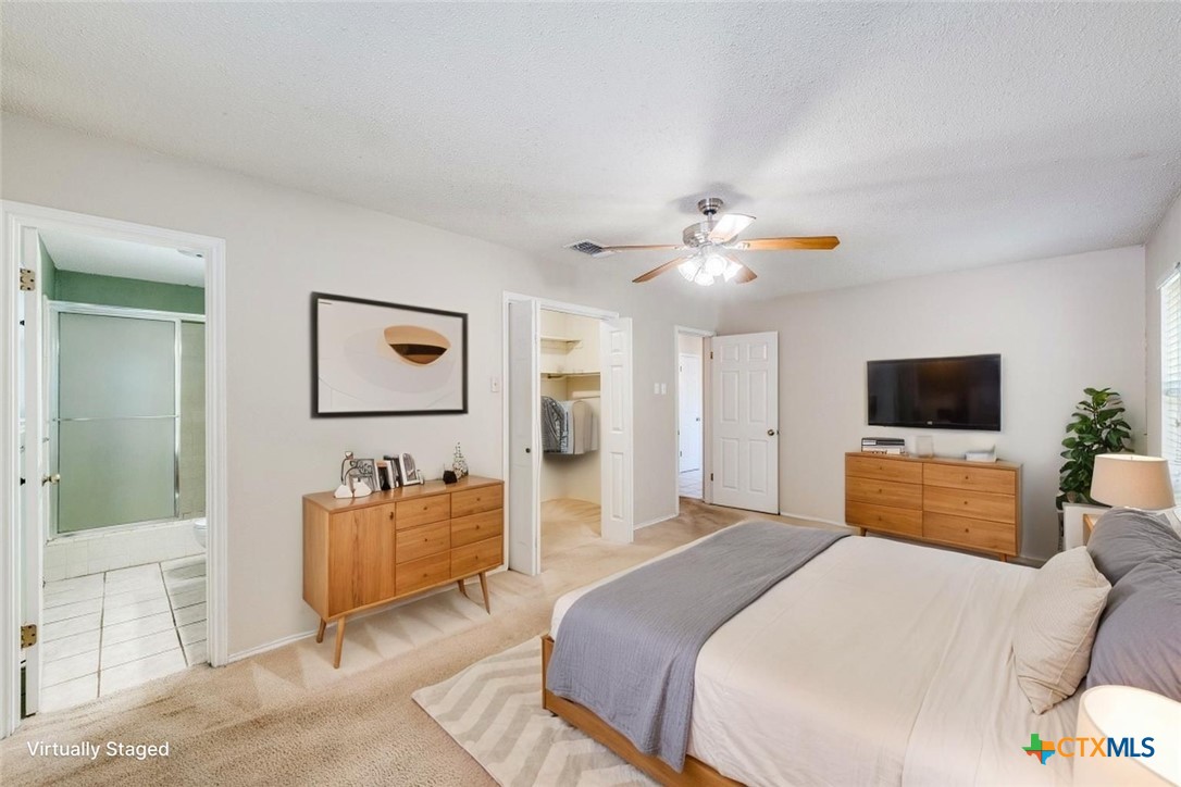 111 Oldtowne Road Seguin, TX 78155 - Photo 15 of 31 a bedroom with a large bed a flat screen tv and a couch