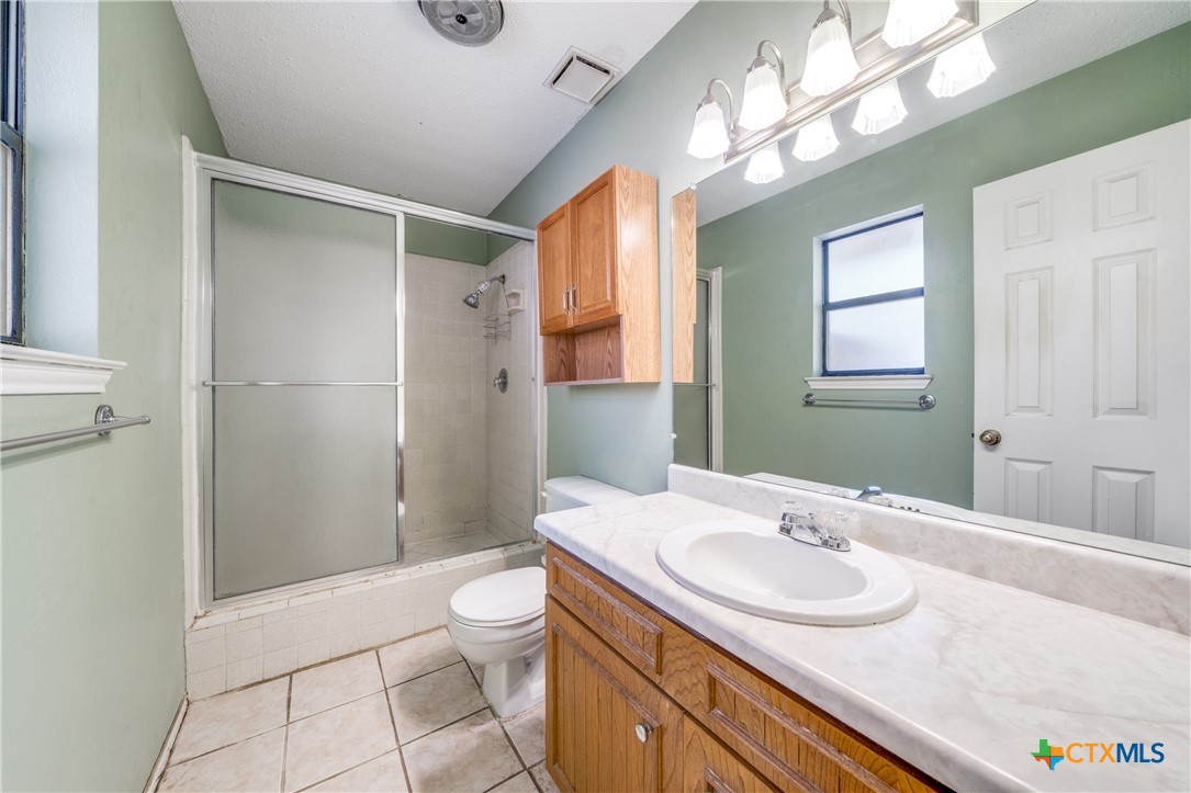 111 Oldtowne Road Seguin, TX 78155 - Photo 17 of 31 a bathroom with a sink a toilet and shower