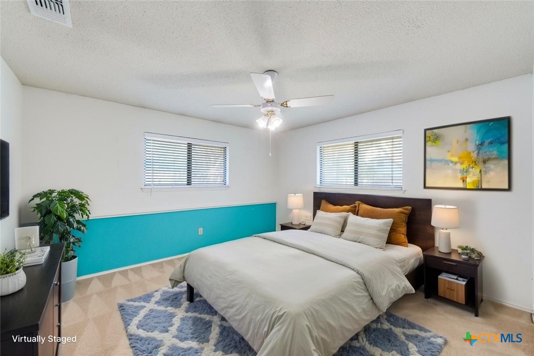 111 Oldtowne Road Seguin, TX 78155 - Photo 19 of 31 a bedroom with a bed and a potted plant