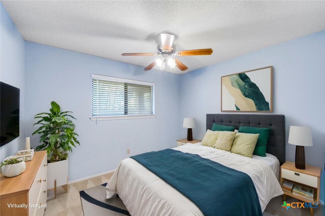 111 Oldtowne Road Seguin, TX 78155 - Photo 21 of 31 a bedroom with a bed and a potted plant