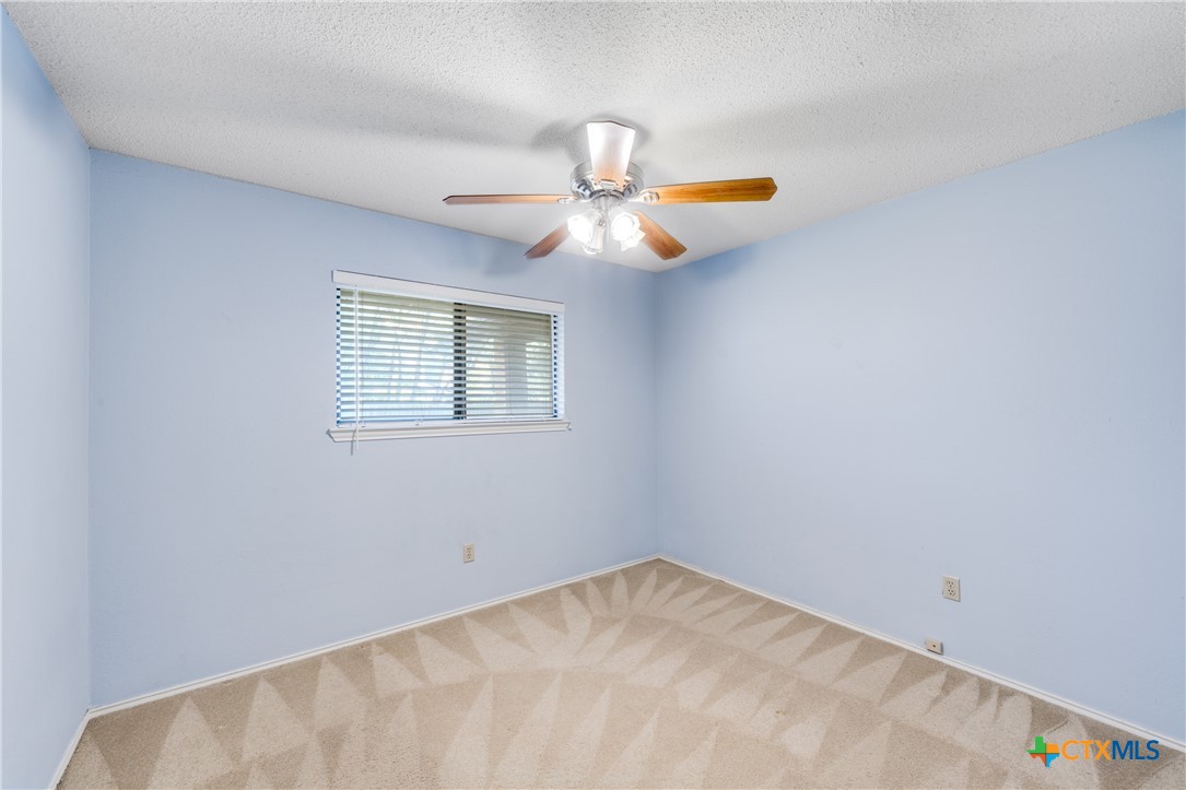 111 Oldtowne Road Seguin, TX 78155 - Photo 22 of 31 a view of a room with a ceiling fan and a window