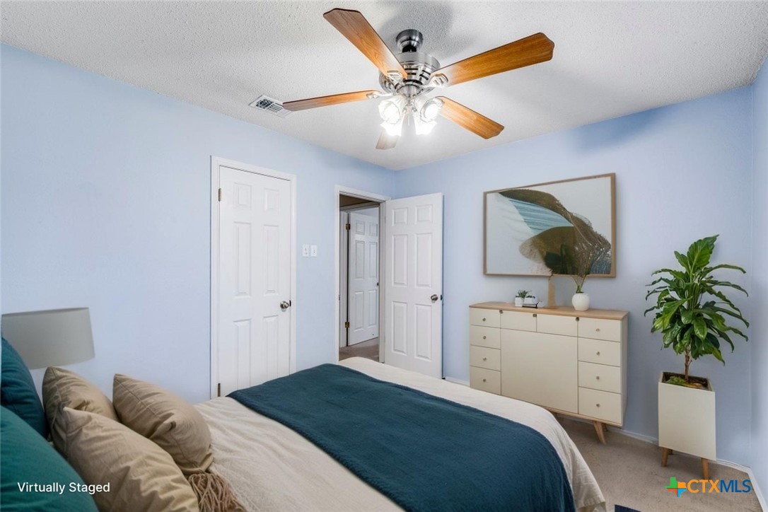 111 Oldtowne Road Seguin, TX 78155 - Photo 23 of 31 a bedroom with a bed and a chandelier