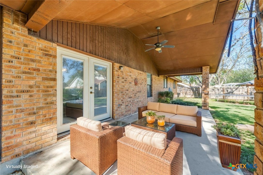 111 Oldtowne Road Seguin, TX 78155 - Photo 28 of 31 a living room with patio furniture and a fireplace