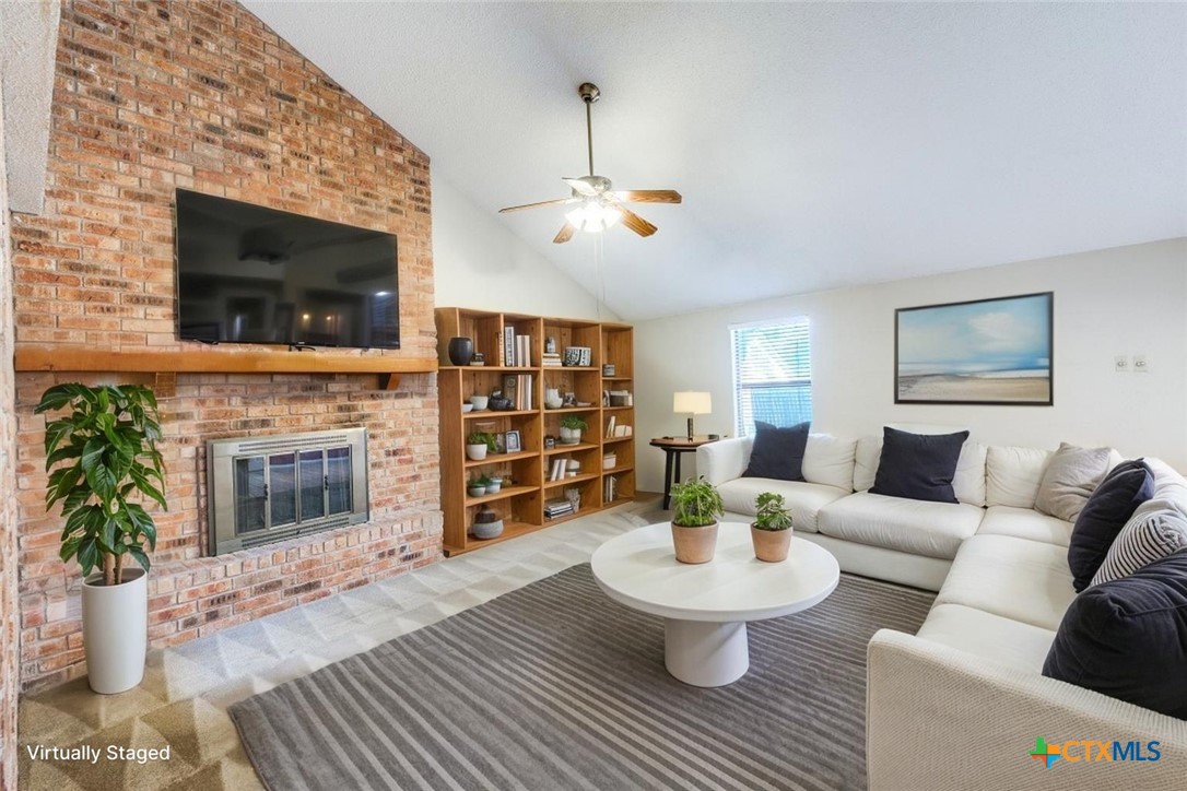 111 Oldtowne Road Seguin, TX 78155 - Photo 4 of 31 a living room with furniture a fireplace and a flat screen tv