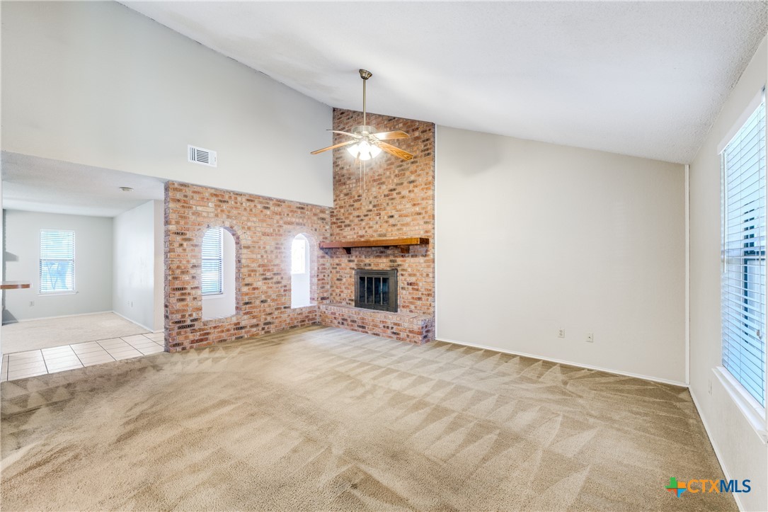 111 Oldtowne Road Seguin, TX 78155 - Photo 7 of 31 a view of an empty room with wooden floor and a window