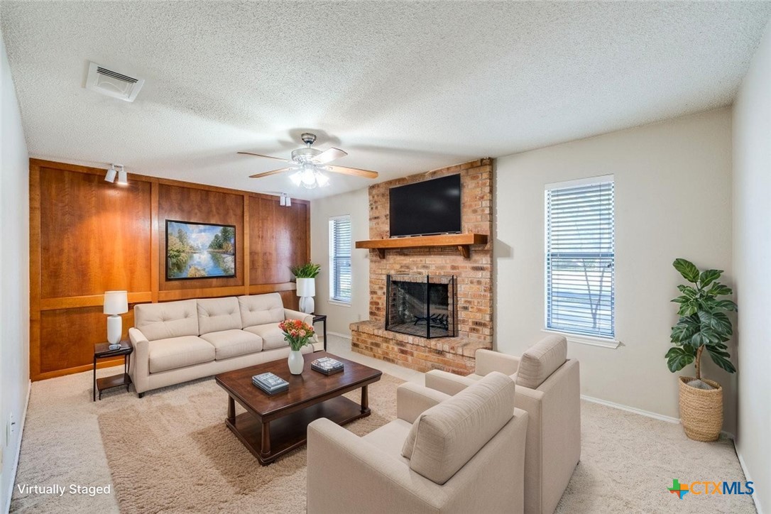111 Oldtowne Road Seguin, TX 78155 - Photo 9 of 31 a living room with furniture a fireplace and a flat screen tv