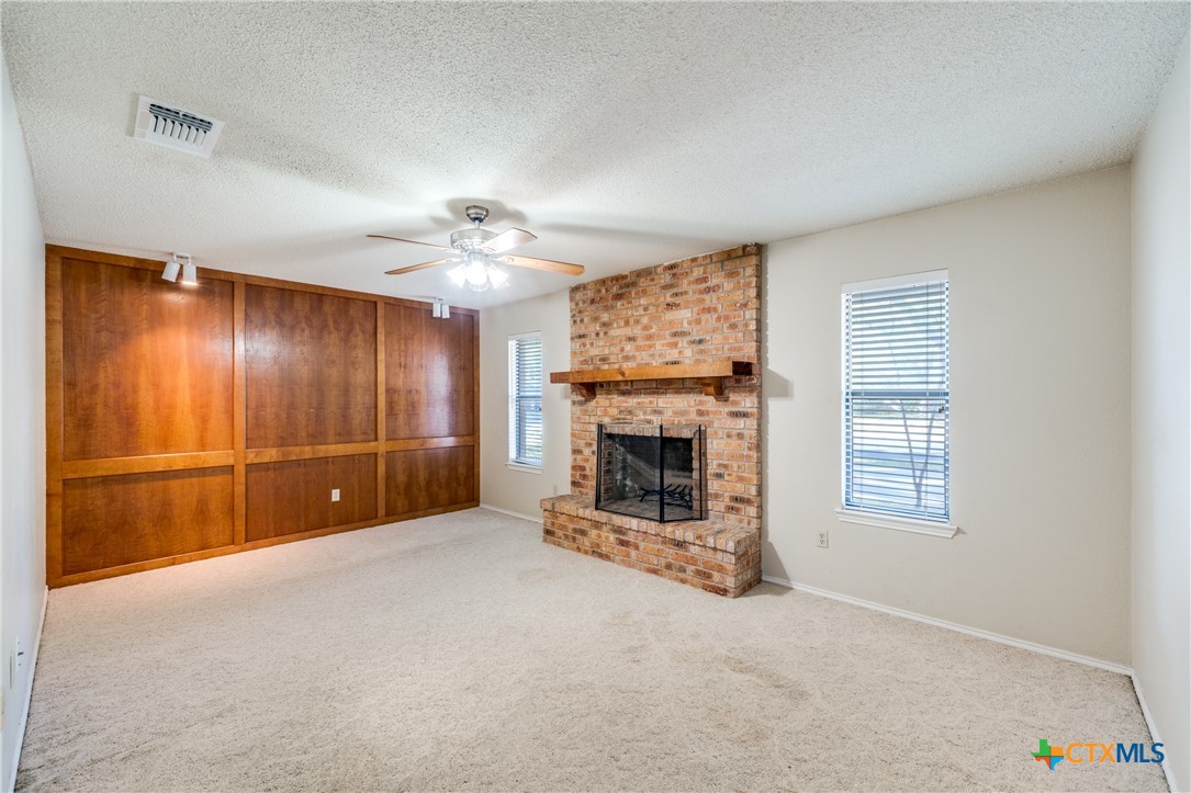 111 Oldtowne Road Seguin, TX 78155 - Photo 10 of 31 an empty room with a fireplace and window