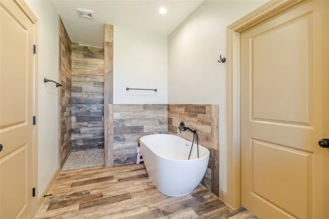 a bathroom with a bathtub and shower