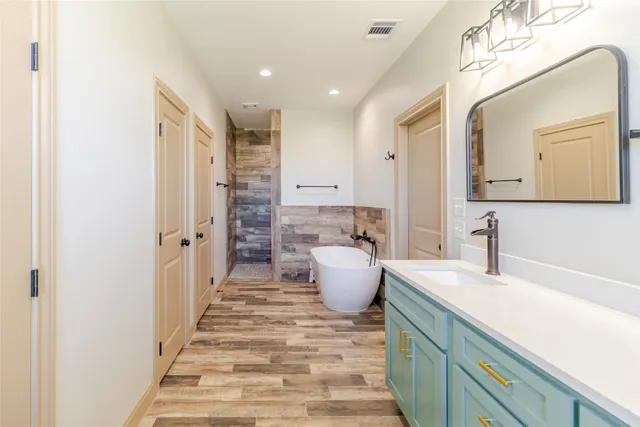 a spacious bathroom with a double vanity sink and a mirror