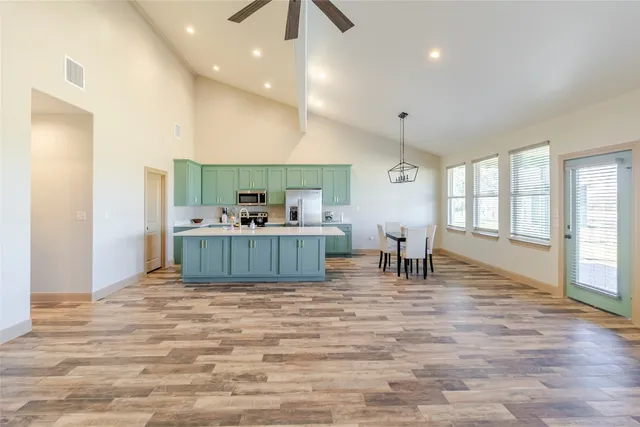 a living room with kitchen furniture and a table
