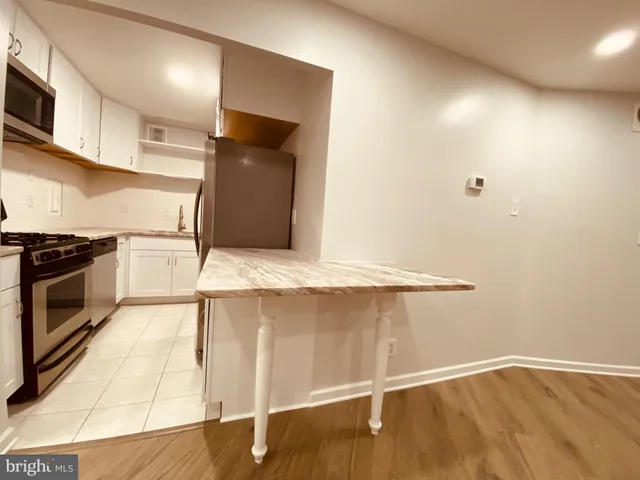 a kitchen with granite countertop a stove and a sink