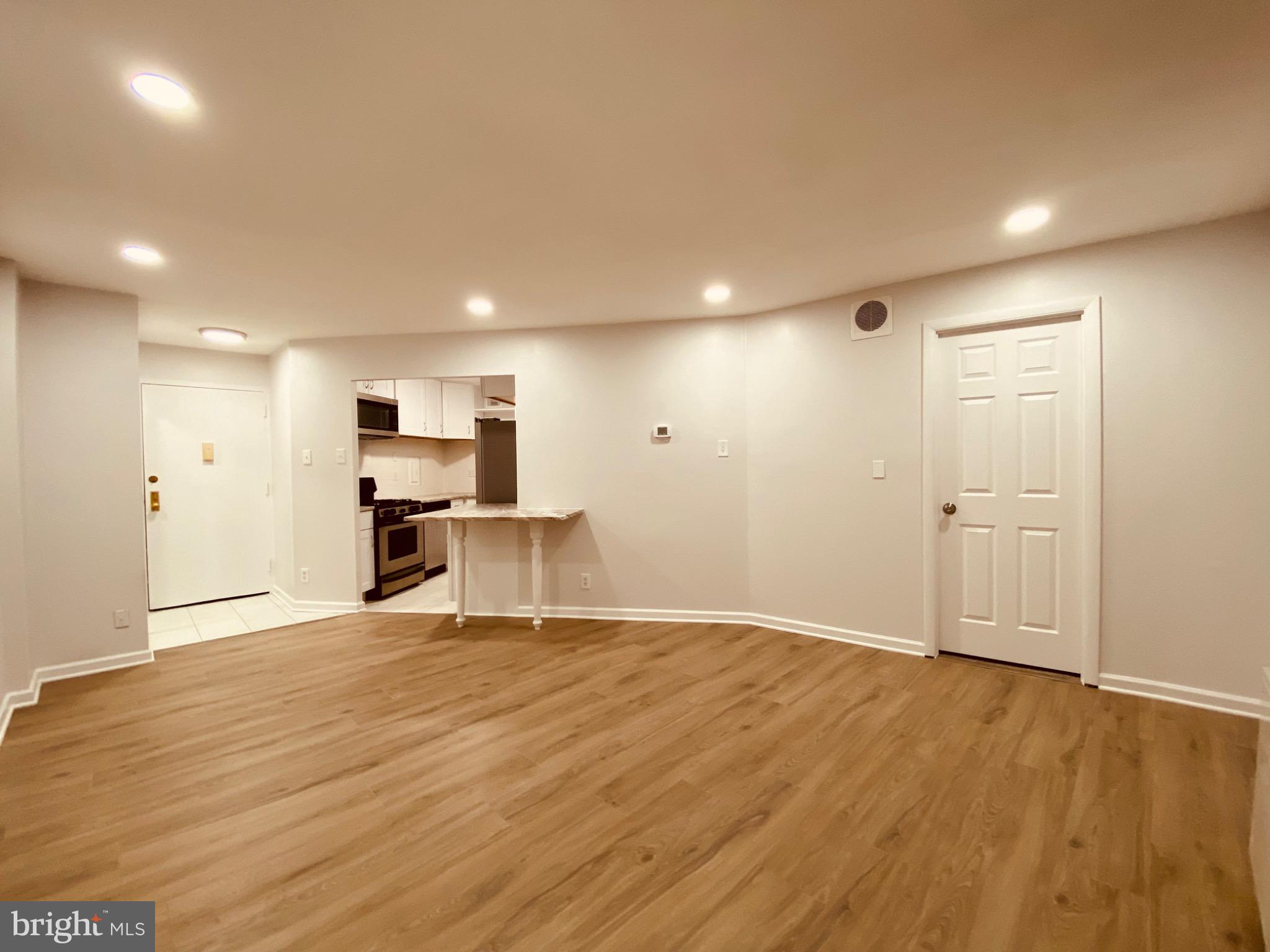 5340 Holmes Run Parkway, Unit 1003 Alexandria, VA 22304 - Photo 4 of 9 Spacious, modern living area with warm tones.