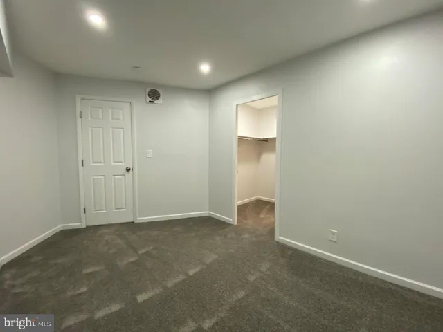 an empty room with closet area
