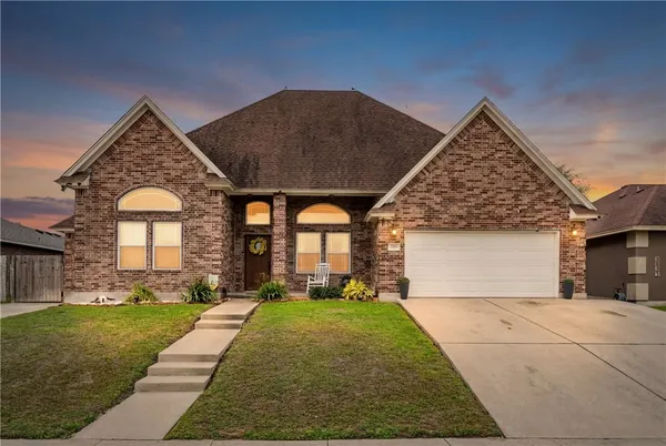 a backyard of a house with table and chairs