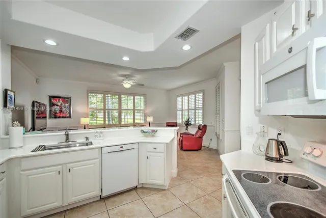 a kitchen with a sink stove top oven and cabinets