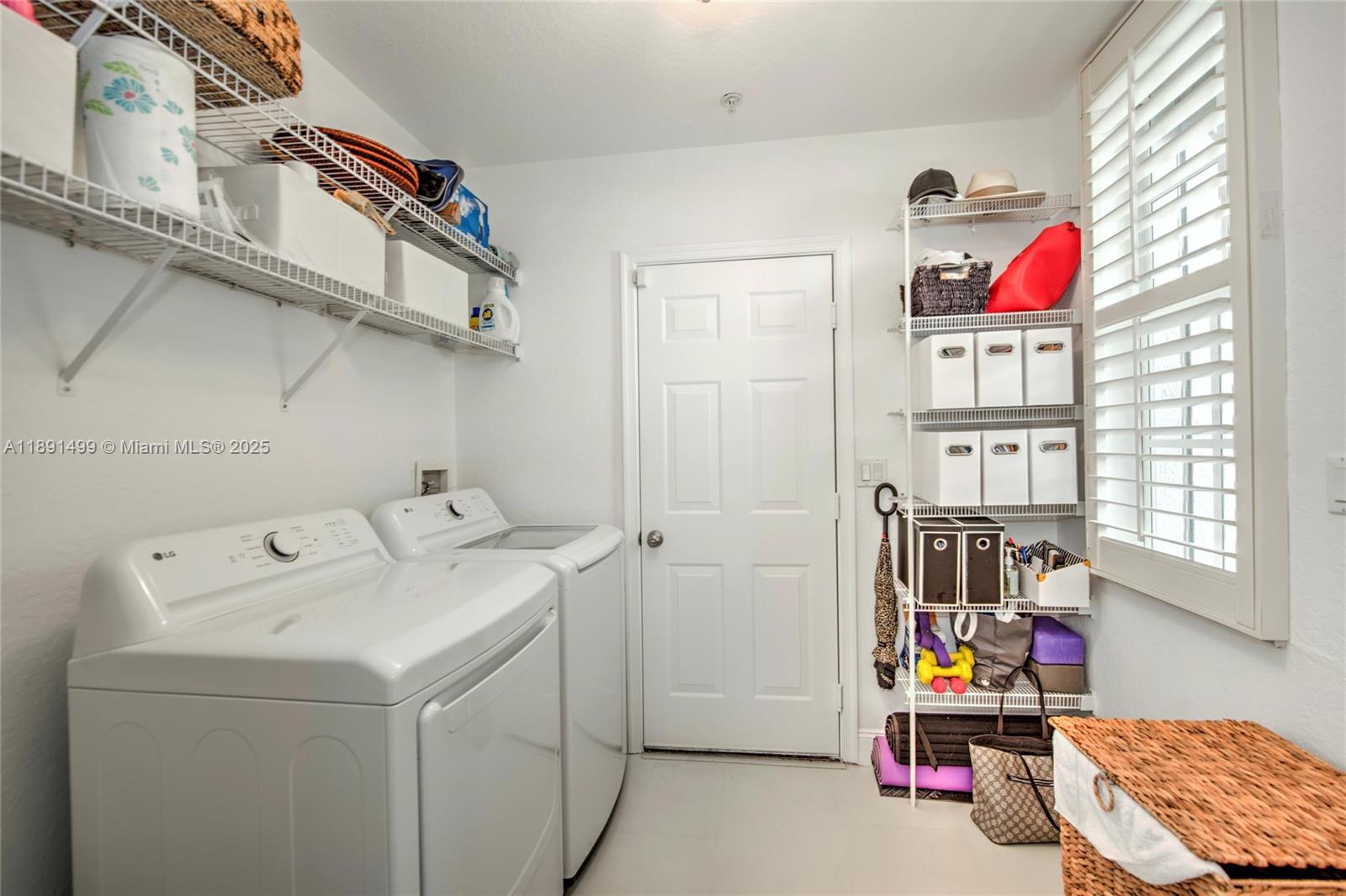 8385 Whisper Trace Way, Unit 104 Naples, FL 34114 - Photo 12 of 18 a utility room with dryer and washer