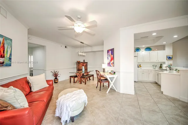 a living room with furniture and kitchen view
