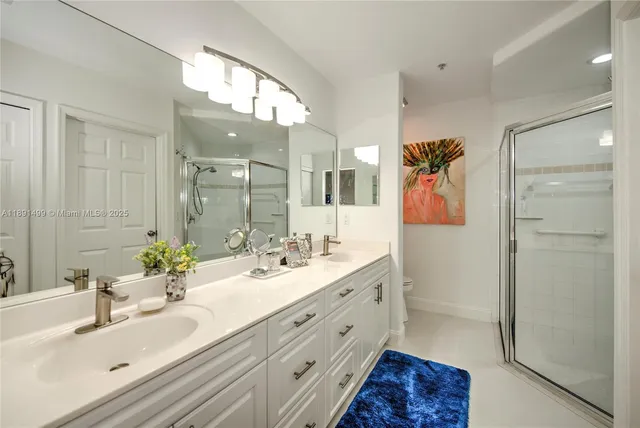 a bathroom with a double vanity sink mirror and double