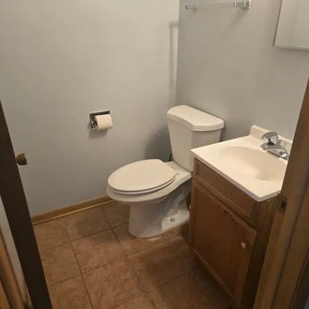 a white toilet sitting next to a bathroom sink