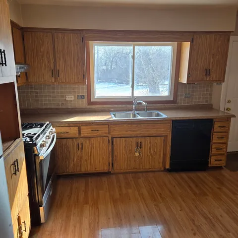a kitchen with a sink a window a washer and dryer