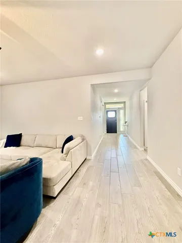 a bedroom with a bed and a night stand