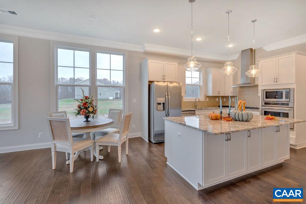 379 Claibourne Road Crozet, VA 22932 - Photo 20 of 38 a living room with stainless steel appliances a dining table wooden floor and a kitchen view