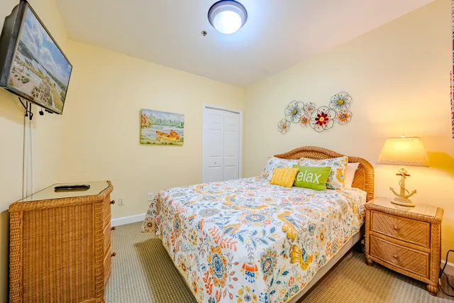 a bedroom with a bed and painting on the wall