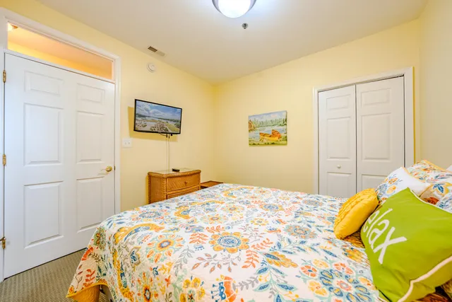 a bedroom with a bed and a painting on the wall