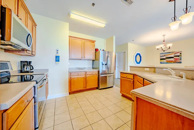 a kitchen with stainless steel appliances granite countertop a sink and a stove