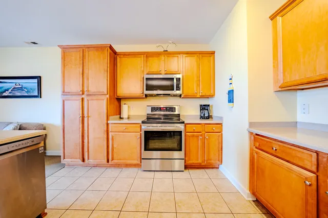 a kitchen with stainless steel appliances granite countertop a stove top oven