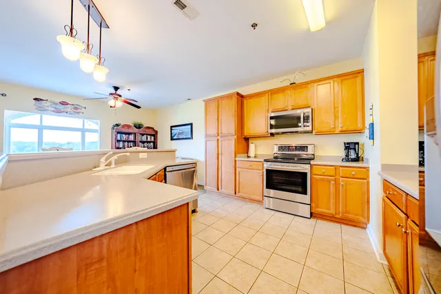 a kitchen with stainless steel appliances a stove a sink and a refrigerator