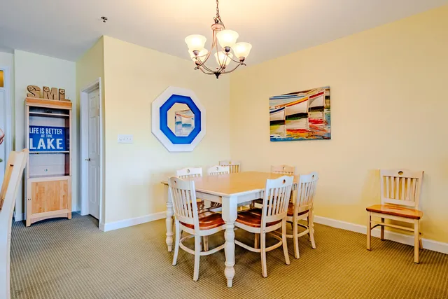 a view of a dining room with furniture and chandelier