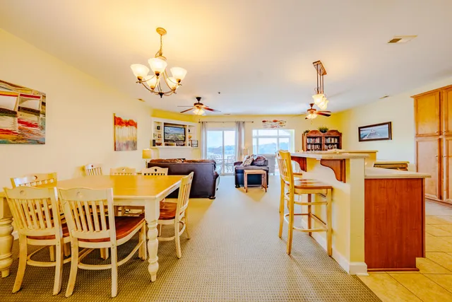 a view of a dining room with furniture and chandelier