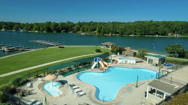 an aerial view of a house with a garden and lake view