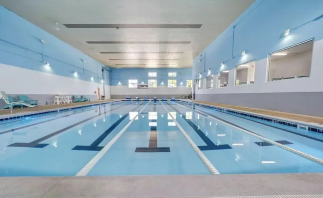 a view of a living room and kitchen with a sink