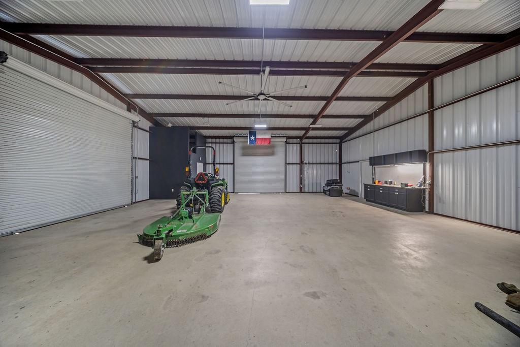 1161 Alsdorf Road Ennis, TX 75119 - Photo 26 of 28 Spacious warehouse interior with high ceilings and exposed metal beam construction