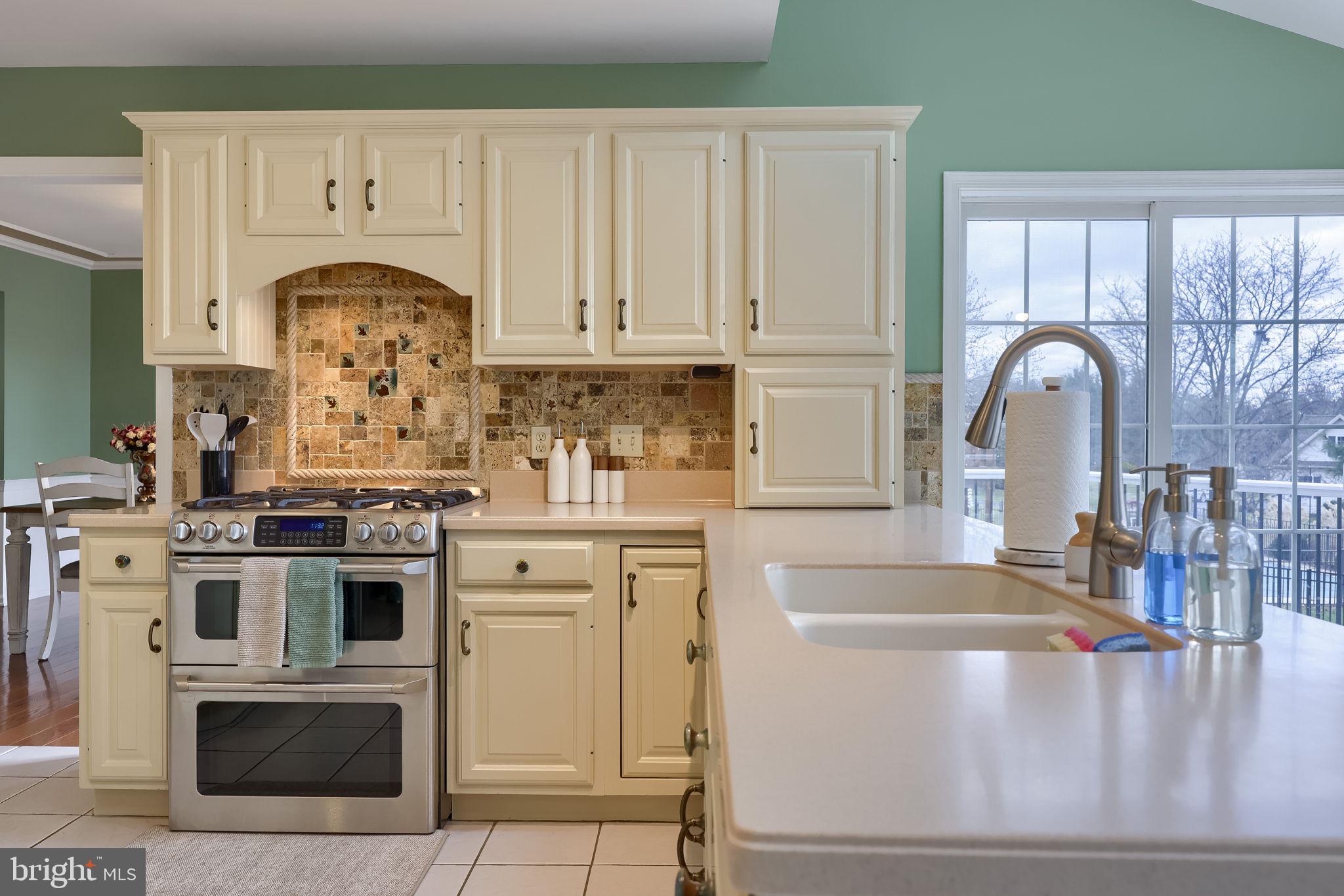 22 Royal Drive Lititz, PA 17543 - Photo 12 of 47 a kitchen with granite countertop a white stove top oven and cabinets