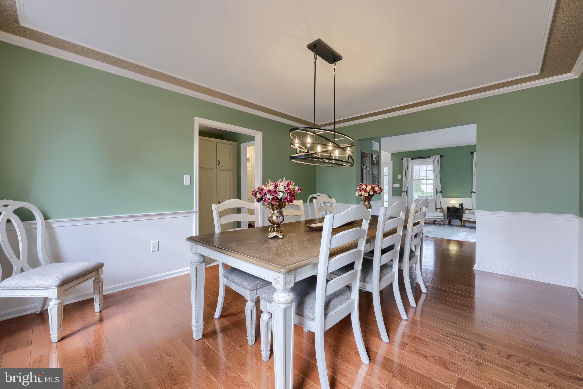 22 Royal Drive Lititz, PA 17543 - Photo 10 of 47 a view of a dining room with furniture a chandelier and wooden floor