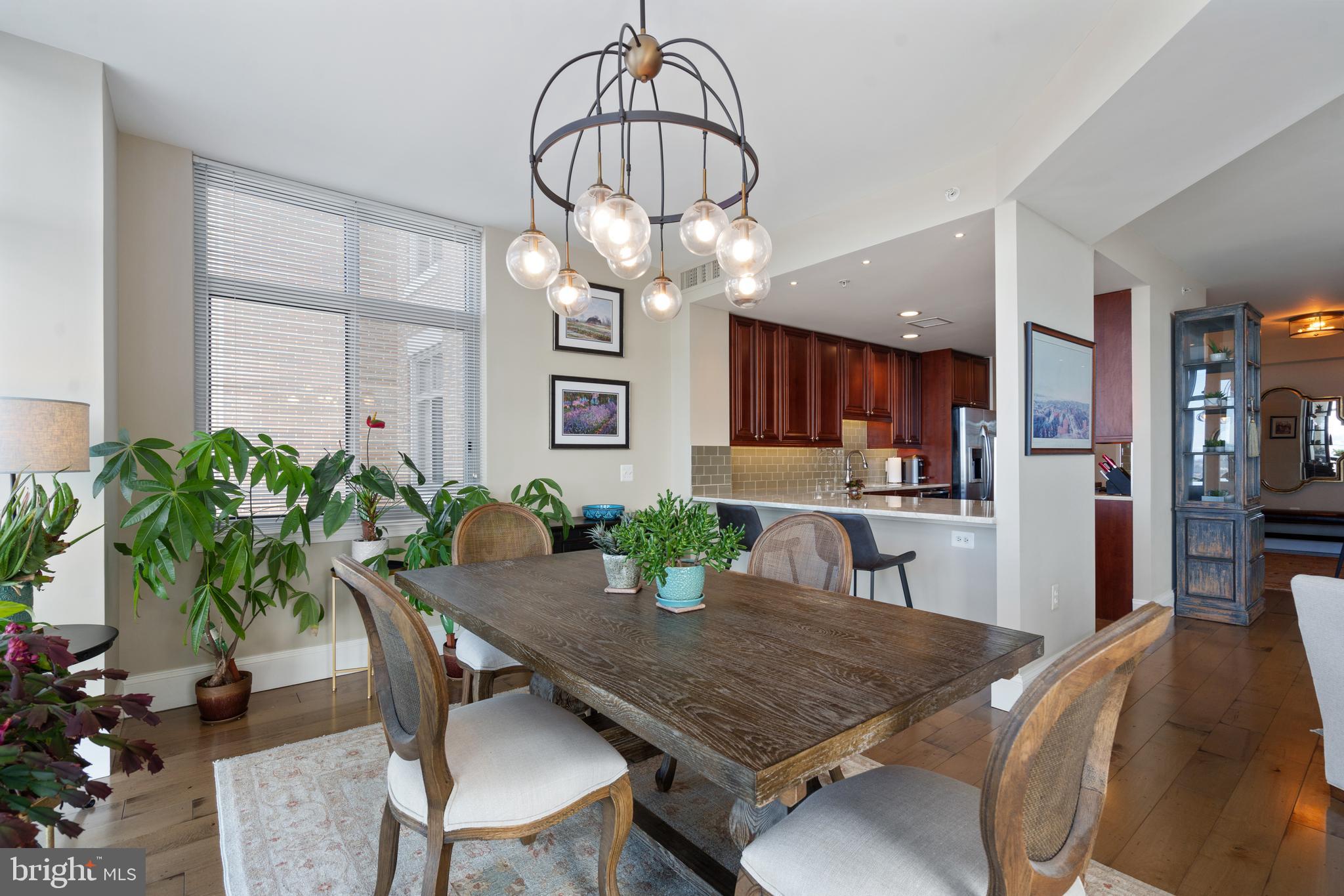 11990 Market Street, Unit 813 Reston, VA 20190 - Photo 12 of 48 a view of a dining room with furniture window and wooden floor