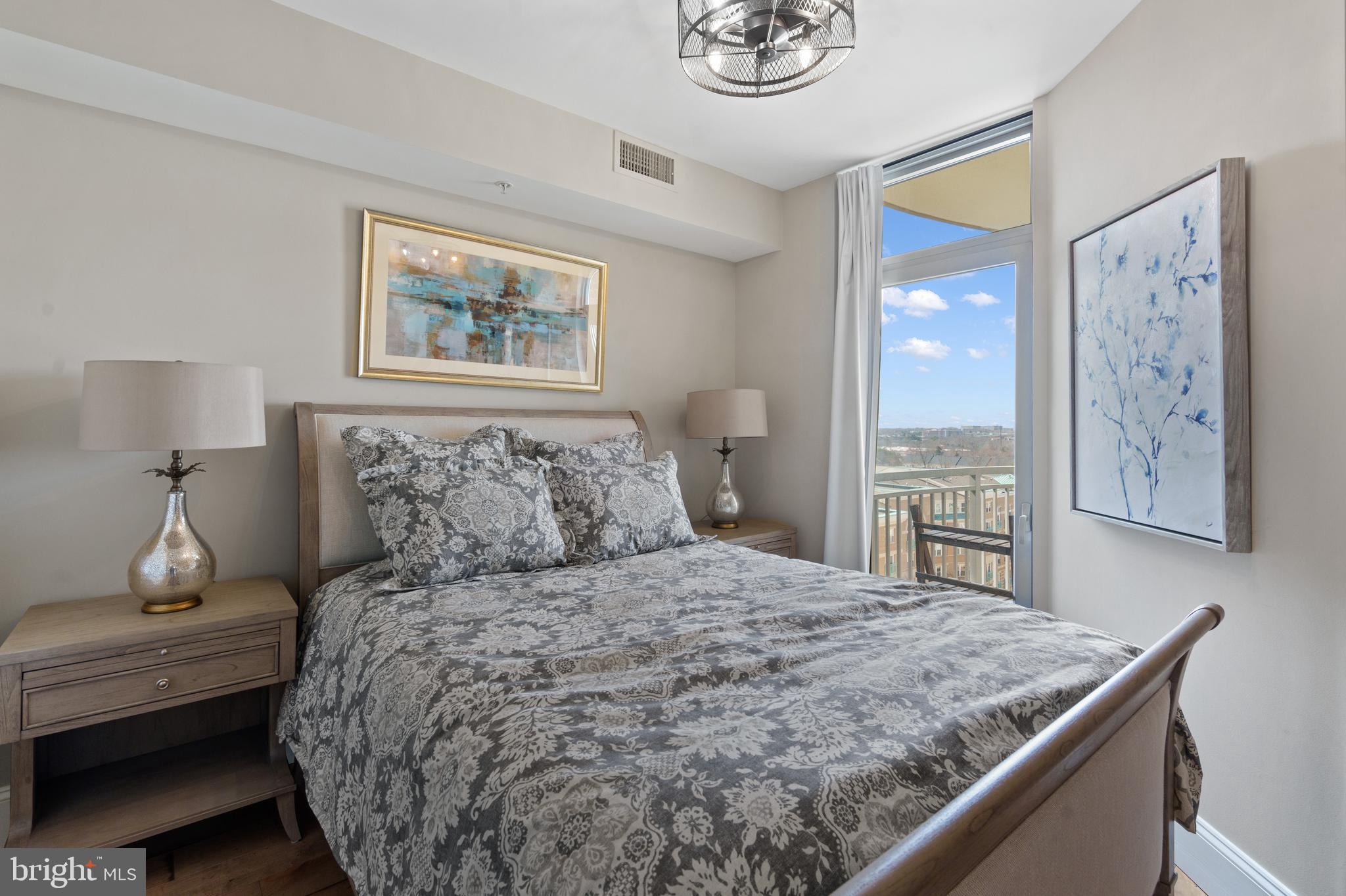 11990 Market Street, Unit 813 Reston, VA 20190 - Photo 14 of 48 a bedroom with a bed and a dresser