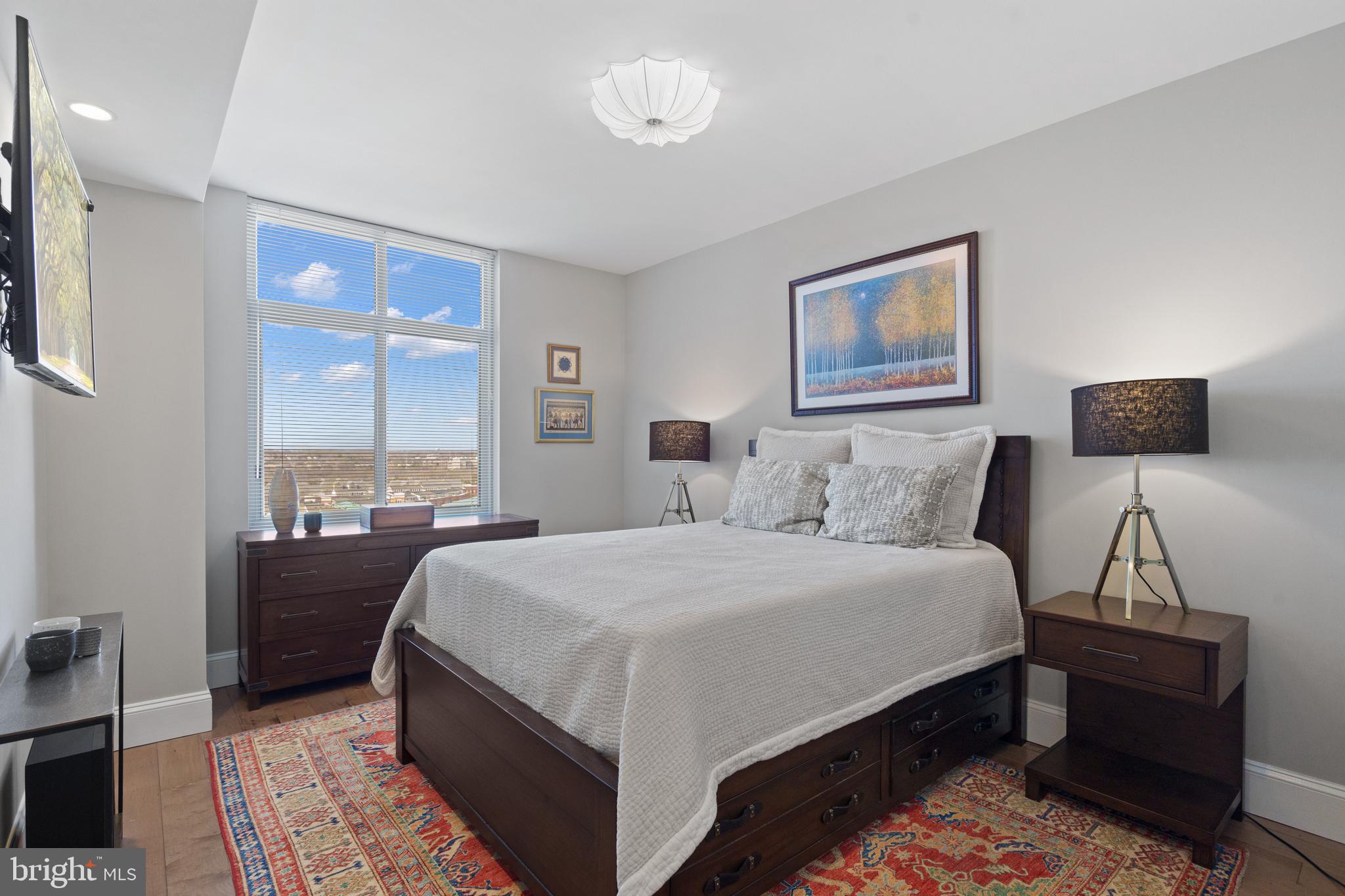 11990 Market Street, Unit 813 Reston, VA 20190 - Photo 19 of 48 a bedroom with bed and wooden floor