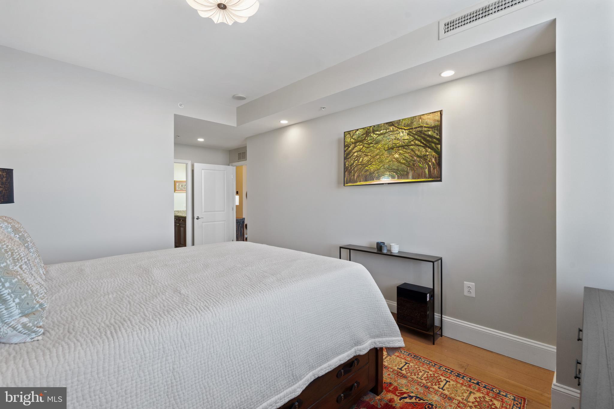 11990 Market Street, Unit 813 Reston, VA 20190 - Photo 20 of 48 a bedroom with a bed and a painting on the wall