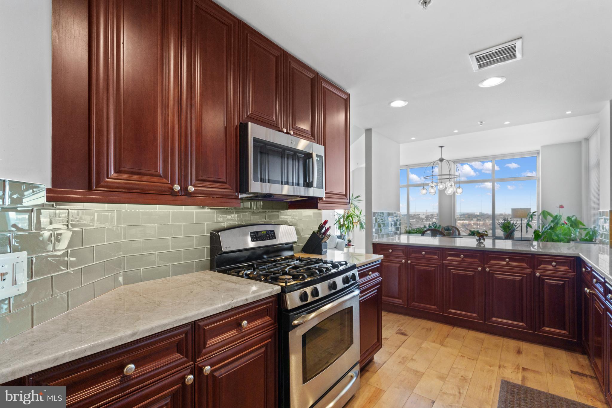 11990 Market Street, Unit 813 Reston, VA 20190 - Photo 4 of 48 a kitchen with a sink stove and microwave