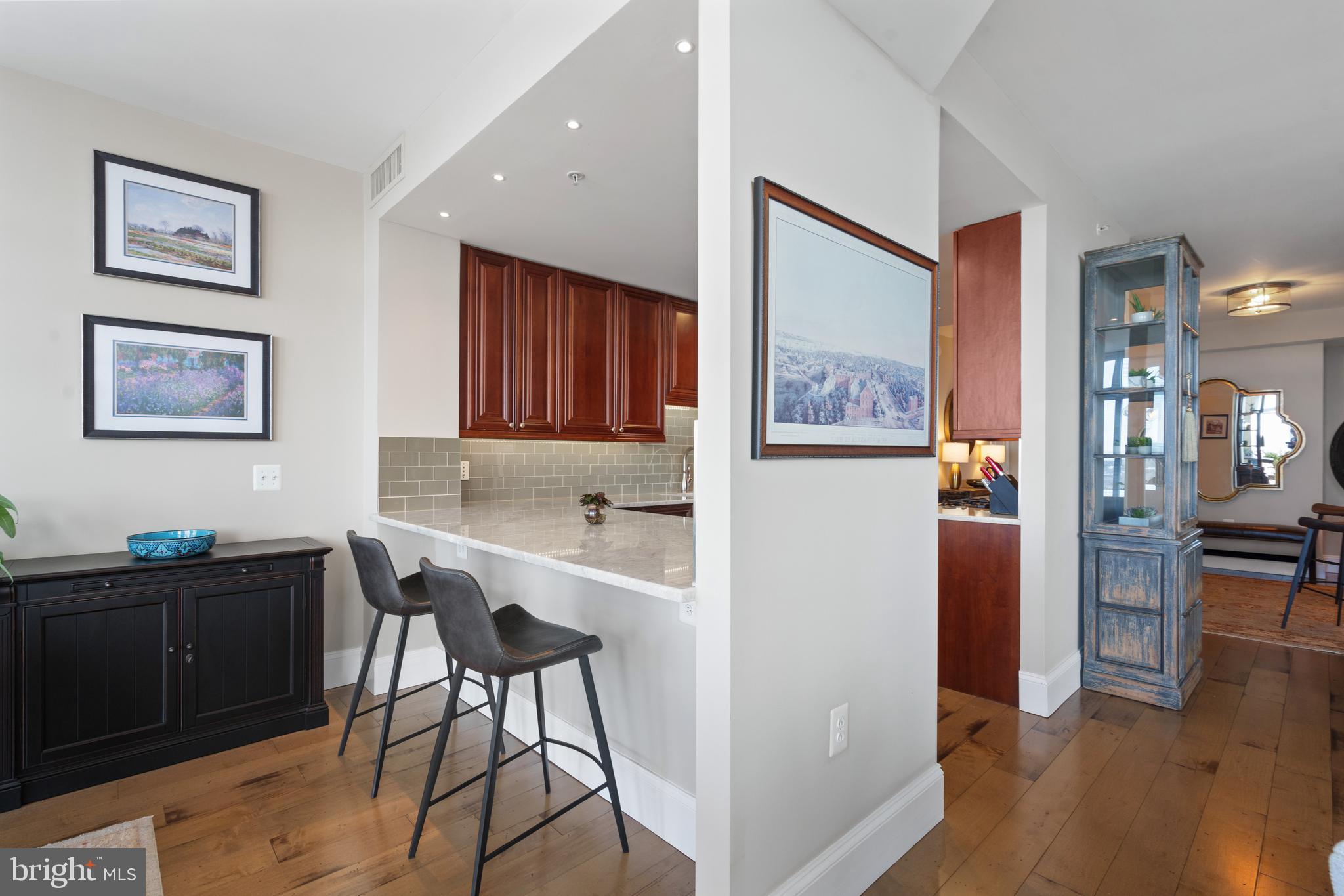 11990 Market Street, Unit 813 Reston, VA 20190 - Photo 7 of 48 a view of a workspace with furniture and wooden floor