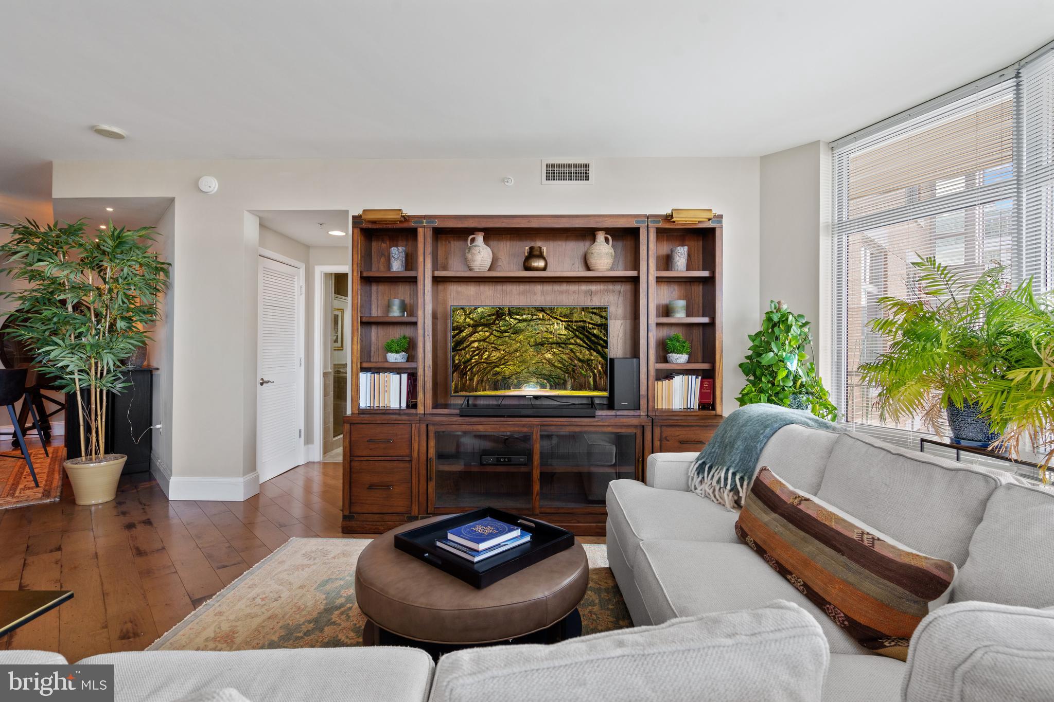 11990 Market Street, Unit 813 Reston, VA 20190 - Photo 10 of 48 a living room with furniture and a large window