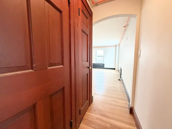 a view of a hallway with wooden floor